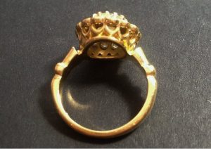 Image of the underside of an 18 carat recycled yellow gold ring with a very elaborate but open undercarriage