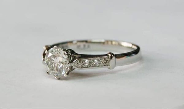 Ring image: Handmade engagement ring. Vintage style eight-claw ring in recycled platinum with a lab-grown diamond as the main stone and recycled diamonds on the shoulders.