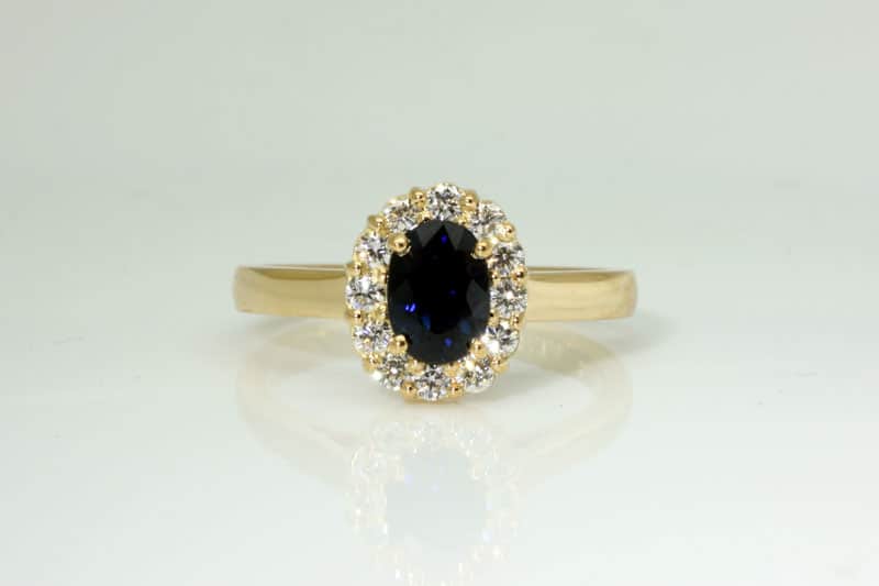 Blue sapphire halo ring with Chi Rho symbol