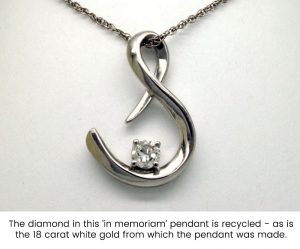 Photo of an S-shaped pendant made with white gold and a diamond recovered from a customer's late wife's rings