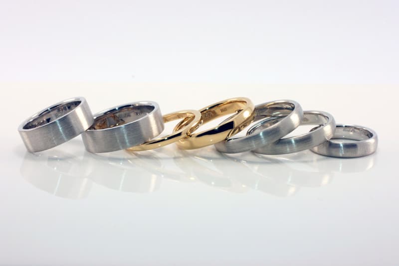 Photo of a selection of wedding style rings in recycled gold and platinum