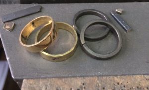 Image of yellow and white gold rings being made