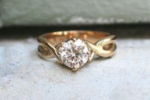 Handmade 18 carat recycled yellow gold crossover style solitaire engagement ring featuring a 6mm moissanite - by Ethical Jewellery Australia